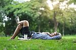 Full Length Happy Smiling Man Lying And Relaxing In Park Stock Photo