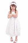 Full Length Portrait Of A Little Girl Standing With Folded Hands Stock Photo