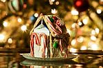 Gingerbread House Against A Background Of Christmas Tree Lights Stock Photo