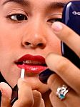 Girl Applying Lip Gloss Stock Photo