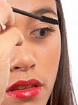Girl Applying Mascara To Eyelashes Stock Photo