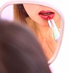 Girl Applying Red Lipstick Stock Photo