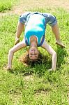 Girl Doing Gymnastic On Grass Stock Photo