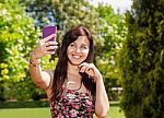 Girl Doing Selfie Mobile Phone In Park Stock Photo