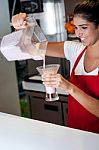 Girl Filling Glass With Strawberry Shake Stock Photo