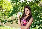 Girl Holding A Credit Card In The Park Stock Photo