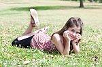 Girl  Laying On Grass Field Stock Photo