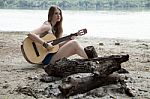 Girl Near Extinguished Campfire On A Sandy Beach Stock Photo