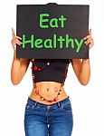 Girl Showing Eat Healthy Sign Stock Photo