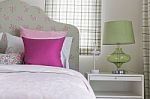 Girl's Bedroom With Pink Pillow On Green Bed Stock Photo
