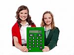 Girls Showing Big Green Calculator Stock Photo