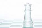 Glass Chess Queen Is Standing On Board, Cut Out From White Backg Stock Photo