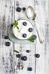 Glass Of Yogurt With Fresh Blueberries Stock Photo
