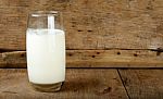 Glass With Milk On The Wooden Background Stock Photo