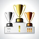 Gold, Silver And Bronze Trophy Cups On Pedestal Stock Photo