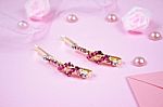 Golden Hairpins With Pink Gemstone On Pink Background Stock Photo