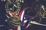 Golden Metal With Ribbon Red White And Blue Around It Laying In Stock Photo