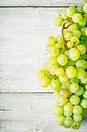 Grapes On The White Wooden Table Stock Photo