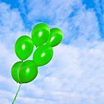 Green Balloons On The Sky Background Stock Photo
