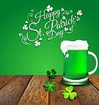 Green Beer With Shamrock On Wooden Floor For St. Patrick's Day Stock Photo