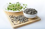 Green Young Sunflower Sprouts On Salad Plate And Sunflower Seeds Stock Photo