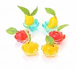Group Of Deletable Imitation Fruits In Jelly Cup On White Floor Stock Photo