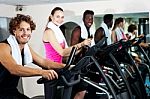 Group Of Friends Cycling In Gym Stock Photo