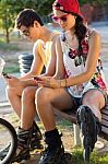 Group Of Friends Texting With Their Smart Phones In The Park Stock Photo