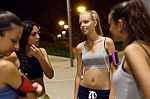 Group Of Girls Doing Stretching At Night Stock Photo