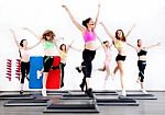Group Of Women Doing Aerobics On Stepper Stock Photo