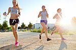 Group Of Women Running In The Park Stock Photo