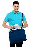 Guy Taking Out Paper From His Laptop Bag Stock Photo