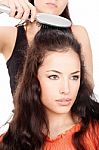 Hairdresser Combing Customer's Hair Stock Photo
