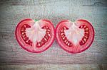 Half Cut Of Red Tomato In Heart Shape Stock Photo