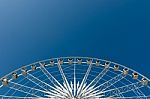 Half Cycle Of White Ferris Wheel Stock Photo