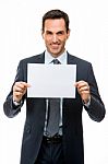 Half Length Portrait Of A Smiling Businessman Holding A Blank Pa Stock Photo