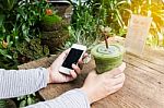 Hand Hold Cool Green Tea And Smartphone Stock Photo