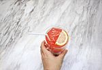 Hand Holding Iced Soft Drink On White Marble Texture Table Backg Stock Photo