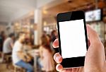 Hand Holding Phone On Coffee Cafe Background Stock Photo