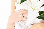 Hand Of A Bride With Ring And Flowers Stock Photo