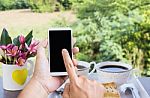 Hand Press On Big Blank Smartphone Screen Or Mobile Phone On Coffee Table Stock Photo