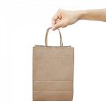 Hand With Paper Shopping Bag Isolated On White Stock Photo
