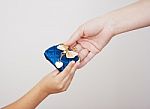 Hands Of Mother Gives The Purse To Her Little Daughter Stock Photo