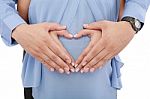 Hands Of Pregnant Woman And Her Husband In Heart Shape Stock Photo