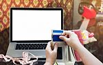 Hands Pull Credit Or Debit Card Out Of Wallet And Laptop Or Note Stock Photo