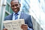 Handsome African Man Reading A Newspaper Stock Photo