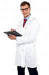 Handsome Doctor Writing Prescription Stock Photo