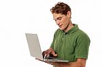Handsome Guy Operating Laptop Stock Photo
