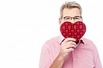 Handsome Man Holding Heart Shape Gift Box Stock Photo