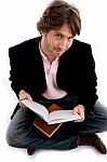 Handsome Sitting Male With Books Stock Photo